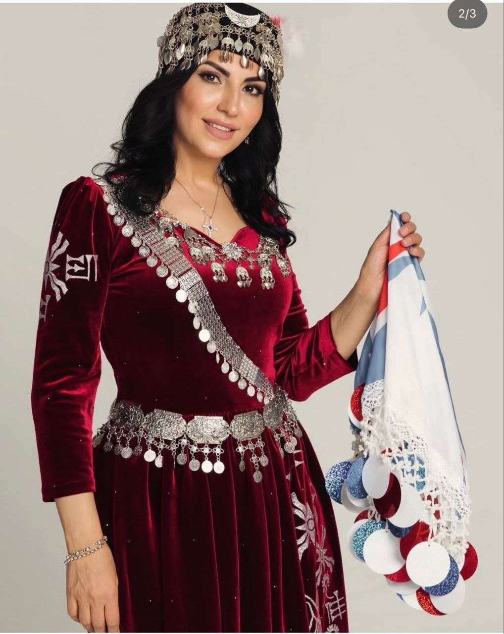 Burgundy Khomala dress with Assyrian motifs, silver ornamentation and a traditional headpiece